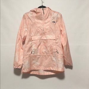 A pink and white North Face Windwall rain coat.